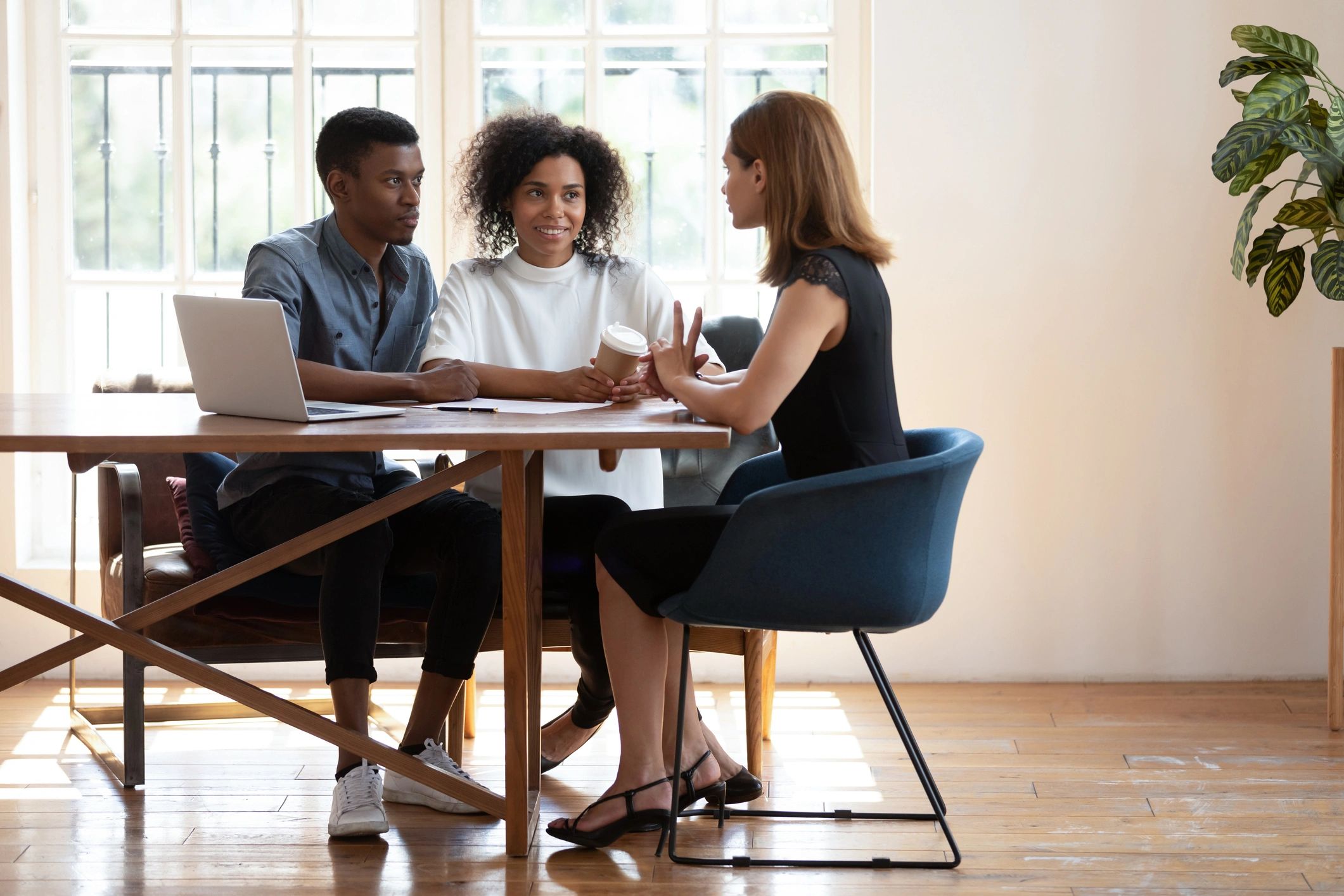 Couple consulting with real estate professional